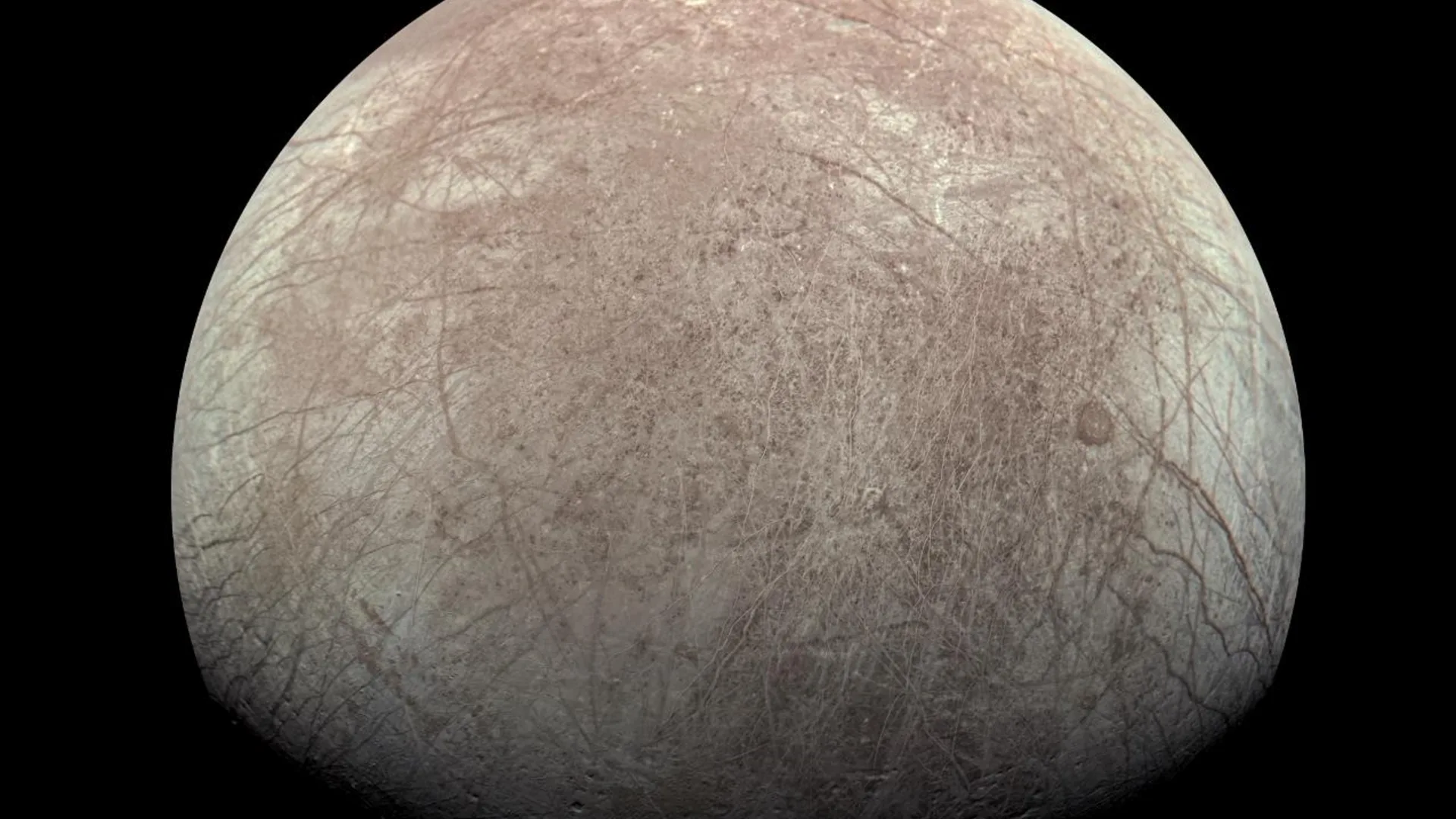 Corte artístico que muestra la corteza de hielo de Europa sobre un océano oscuro
